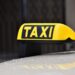 yellow and black taxi sign