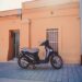 a scooter is parked in front of a building