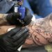 person with tattoo on right arm